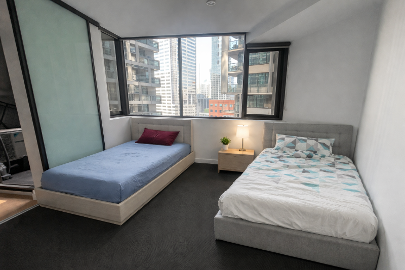 Modern high-rise bedroom with twin beds.png